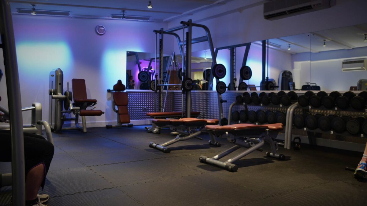 Fitness equipment and weights on interlocking rubber gym mats